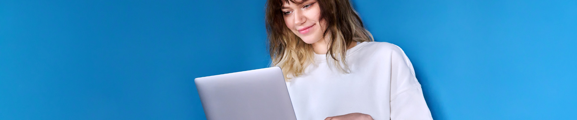 Photograph of person holding a laptop